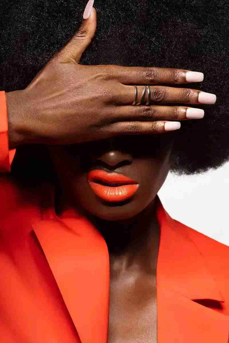 Nails and red lipstick makeup girl with red body makeup and white hair paint