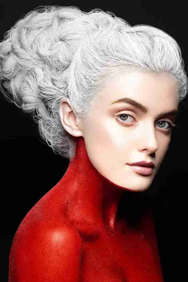 girl with red body makeup and white hair paint