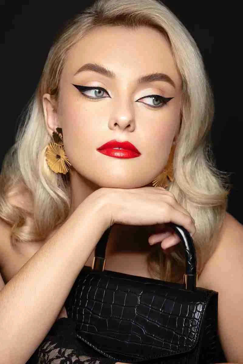 girl with red lipstick holding a handbag